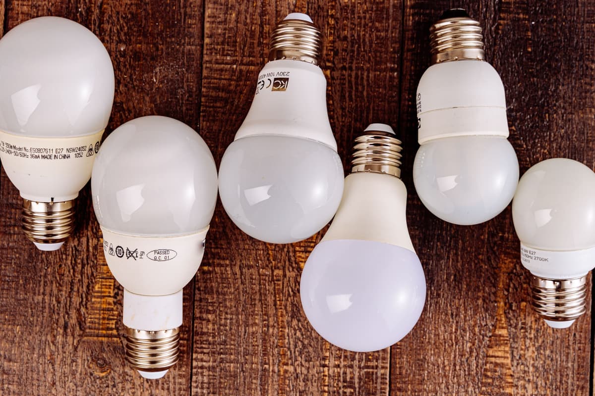 Several LED bulbs of different shapes on a plain table