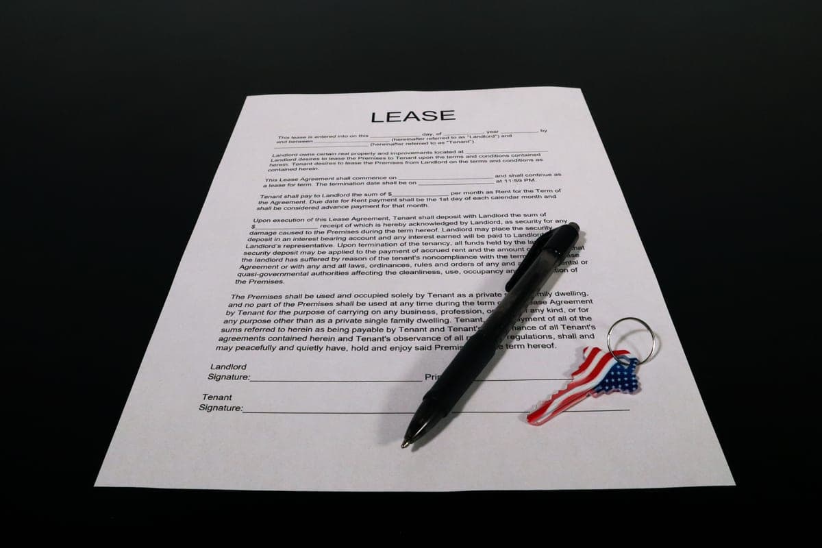 Apartment keys resting on a lease document on a table
